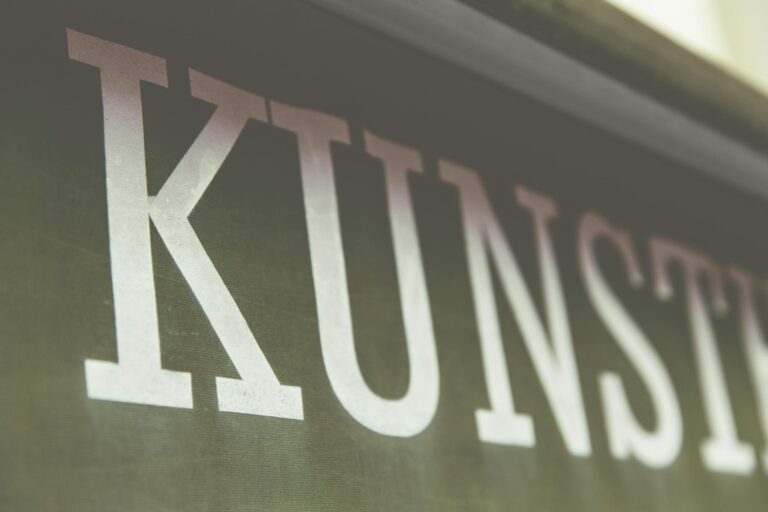 Close-up image of the word 'Kunst' in a stylish font on a dark background.